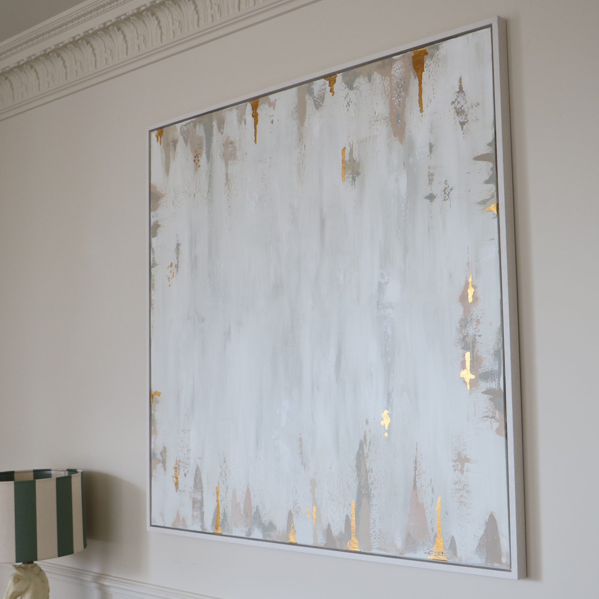 Abstract art piece on a wall with gold accents