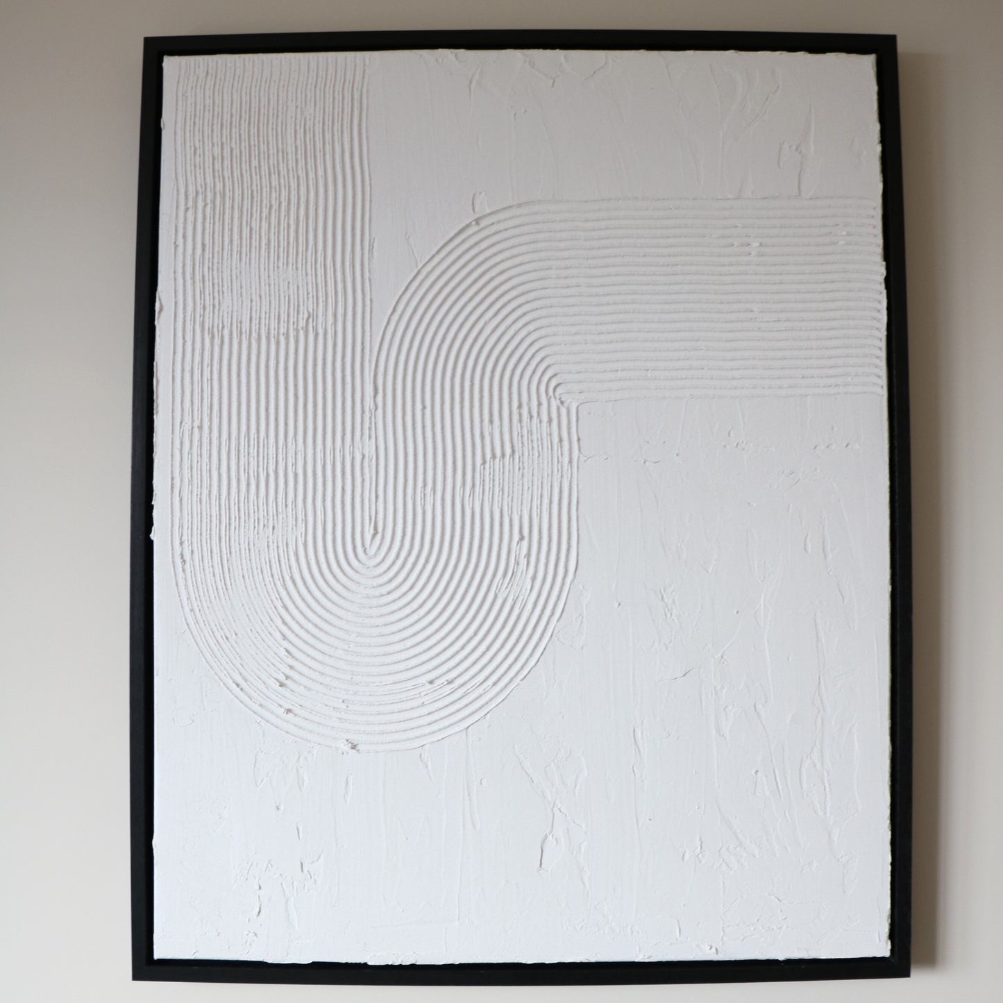 Abstract textured artwork with concentric circular patterns on a white background
