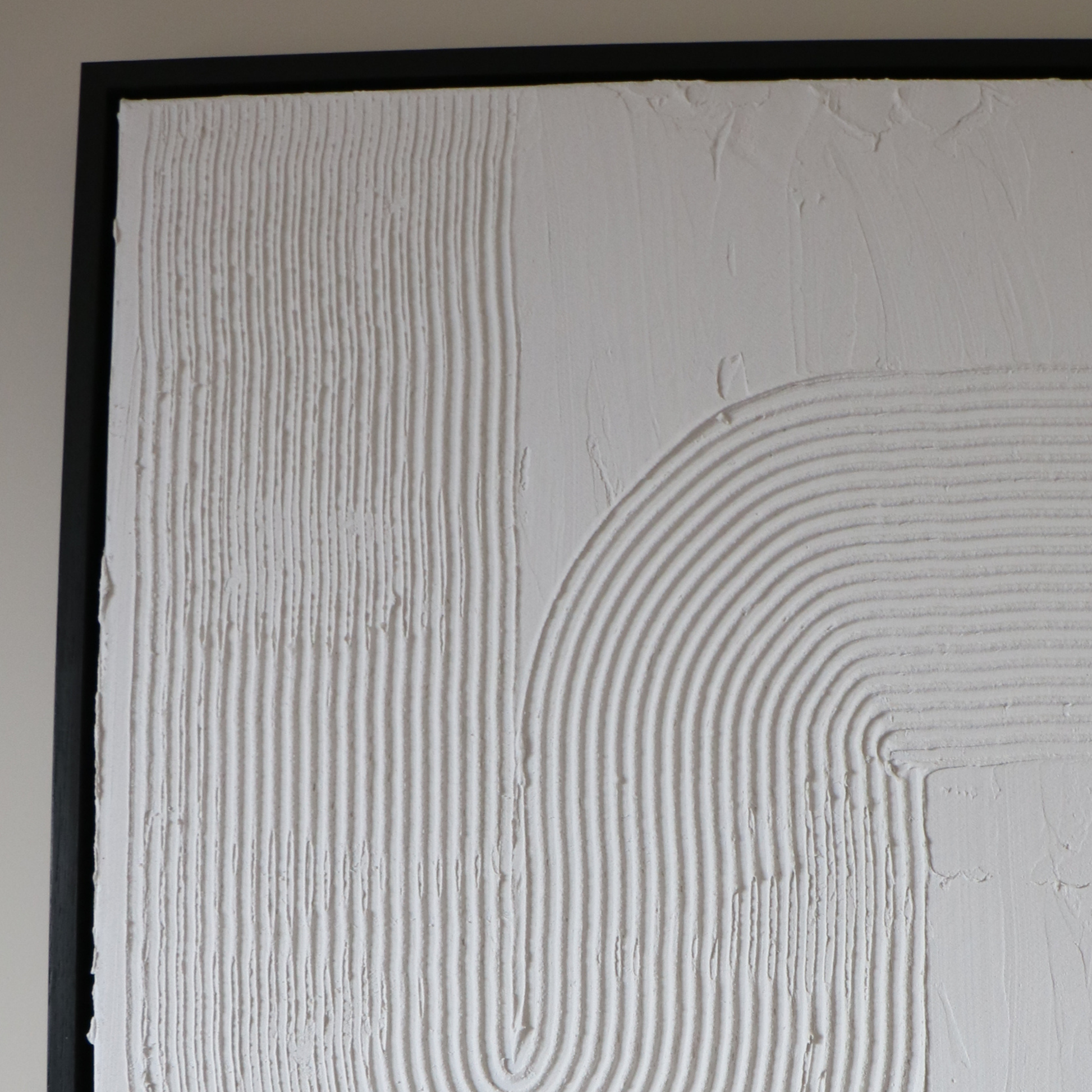 Textured white art with black frame